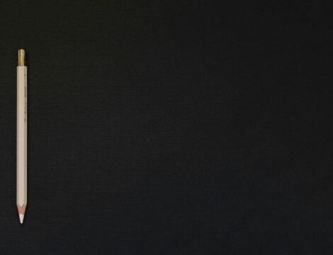 Crayon de couleur blanc posé sur un fond noir